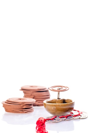 Mini incense coil burning with stack of coils and chinese old coins at the backgroundの写真素材