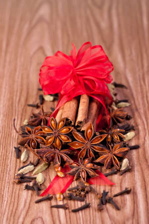 A variety of spices wrapped with a red ribbon for Christmasの写真素材