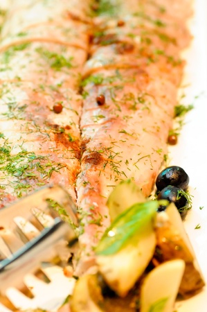 Baked salmon with  fresh herbs and olives close upの写真素材