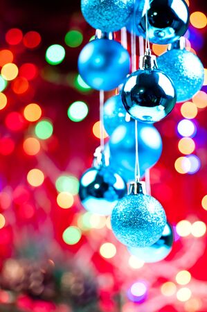Blue Christmas hanging baubles with lights and decorations at the backgroundの写真素材