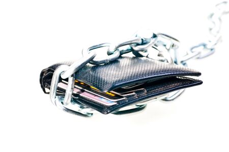 Chained black wallet indicating stop spending moneyの写真素材