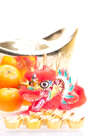 Chinese new year with dragon decoration, large gold ingot and mandarin orangesの写真素材