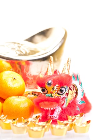 Chinese new year with dragon decoration, large gold ingot and mandarin orangesの写真素材