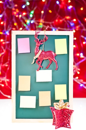 Christmas notice board with santa's rain deer, present decoration and sticky notes on the boardの写真素材