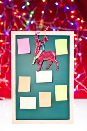 Christmas notice board with santa's rain deer decoration and sticky notes on the boardの写真素材