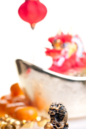 Close up of dragon for chinese new year with mandarin oranges, ingots, lantern and dragon decoration at backgroundの写真素材