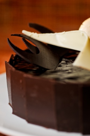 Dark chocolate  cake decorated with white and dark chocolate piecesの写真素材