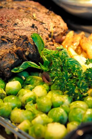 Juicy roast beef with sauteed brussels sprouts and potatoesの写真素材