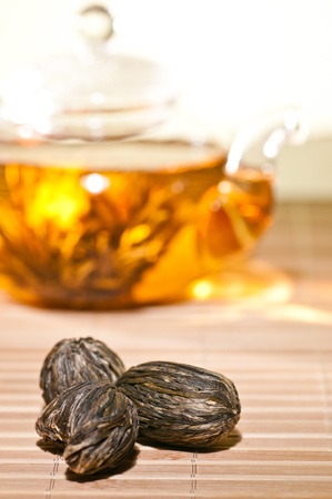 Dry blooming tea closeup with glass teapot at backgroundの写真素材
