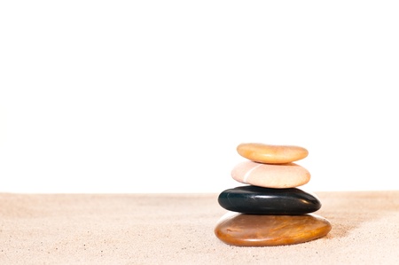 Yellor river stone, sandstone,black zen stone and red zen stone stacked on sandの写真素材