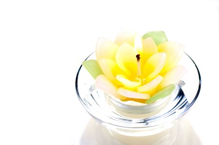 Lotus candle with a flame close upの写真素材