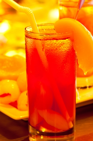 Ice peach tea with peaches at the backgroundの写真素材