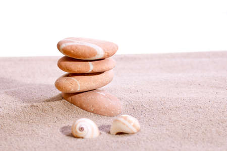 A few sand stones on beach sand with  a bright backgroundの写真素材