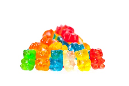 A stack of colorful gummy bears and six colorful gummy bears line upの写真素材