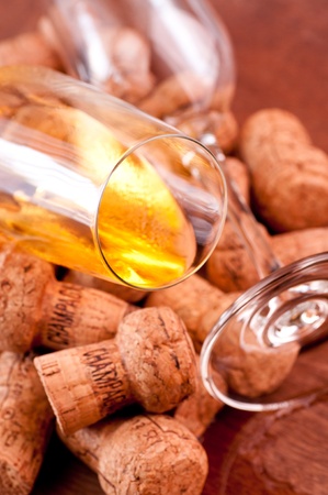 Champagne corks and spilled champagne on a wooden tableの写真素材