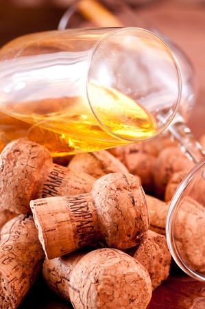 Champagne corks and spilled champagne on a wooden tableの写真素材