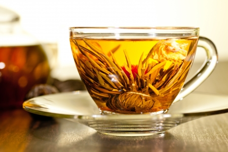 Blooming flower tea in a glass cup close upの写真素材