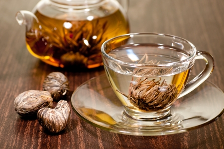 Blooming tea in a glass cup with variety of hand made teasの写真素材