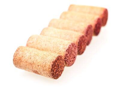 Six wine corks in a line over whiteの写真素材