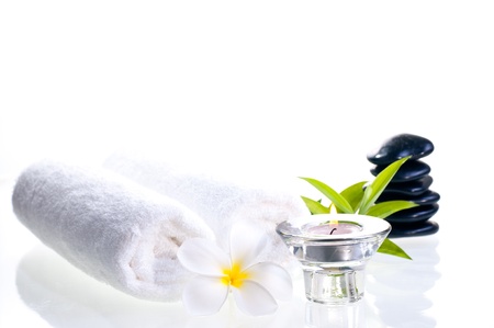 Spa concept with black zen stones and white flower over white backgroundの写真素材