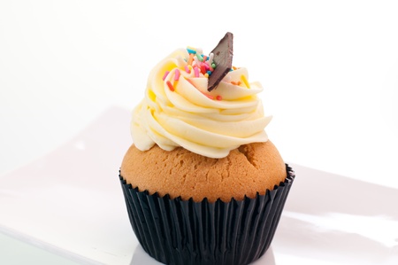 Vanilla cupcake close up on a white plateの写真素材