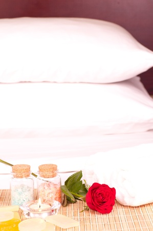 In room romantic spa concept with rose, bath salts and towelの写真素材