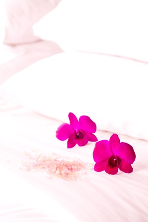 Spa concept orchids and bath salt on the bed in a resortの写真素材