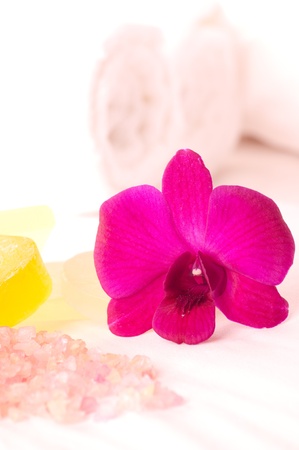 Spa concept orchids, bath soap and bath salt on a bed の写真素材
