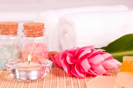 Spa holiday with a pink ginger flower in a hotel roomの写真素材