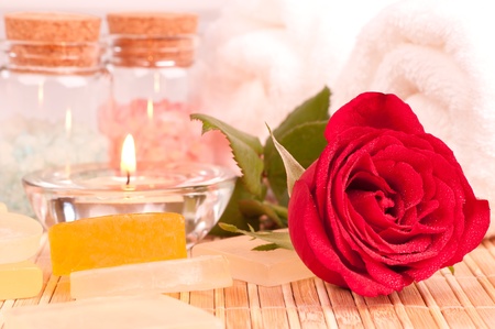 Romantic spa break with a red rose on a bamboo mat close upの写真素材