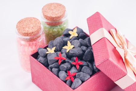 Spa wellness gift concept with black zen stones and flowers