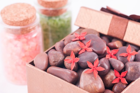 Spa concept - a gift of wellness with red zen stones and flowersの写真素材