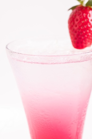 Red Sip Cocktail close up, made from strawberry liqueur, triple sec and topped up with soda and garnished with a fresh strawberryの写真素材