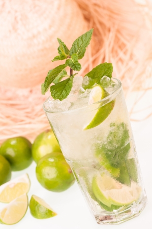 Lime Mojito cocktail with a straw hat background の写真素材