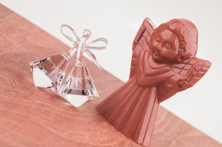 Chocolate Angel and Crystal Bells Ornament on wooden tableの写真素材