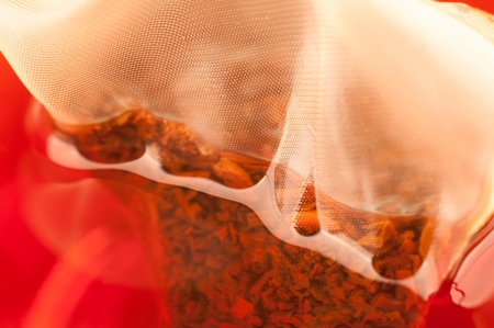 Silky pyramid tea bag in a cup extreme close upの写真素材