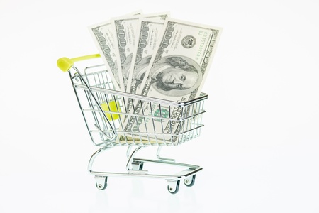 US hundred dollar bills in shopping cart over white backgroundの写真素材