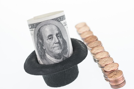 One hundred dollar bill and one hundred pennies の写真素材