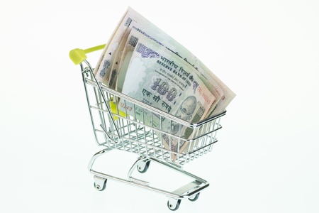 Indian rupees in shopping cart over white backgroundの写真素材
