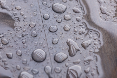 Rain water drops pattern on wooden deck top view close upの写真素材