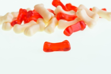 Red gummy bone candy close-up with gummy bones candy at the background の写真素材