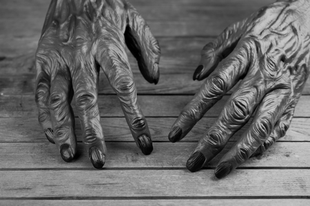 Werewolf hands on wooden background in black and white の写真素材