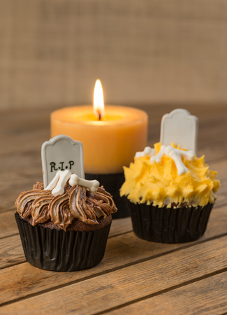 Variation of Halloween cupcakes and candle at the background の写真素材
