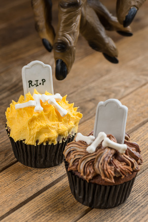 Trick or Treat concept whereby werewolf finger pointing towards the cupcakes の写真素材