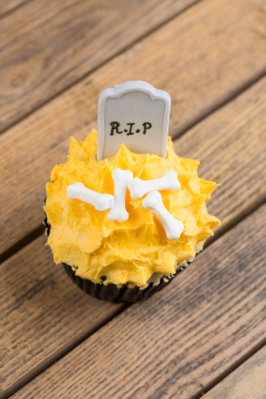 Halloween cupcake on a rustic wooden table top view の写真素材