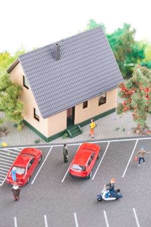 Miniature people, town house and a busy street top view の写真素材