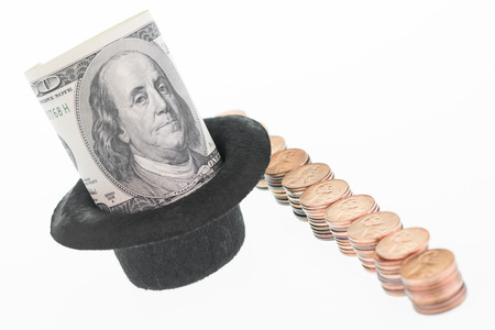One hundred US dollar banknote and a row of pennies の写真素材