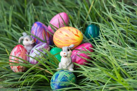Easter bunnies and eggs on the green grass backgroundの写真素材