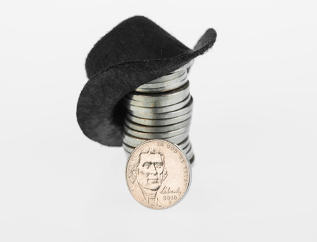 Black cowboy hat and nickels close up over white background の写真素材