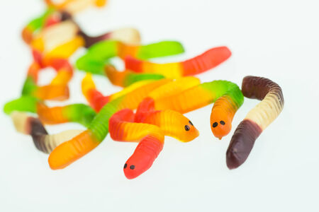 Gummy worms candy close up over white backgroundの写真素材